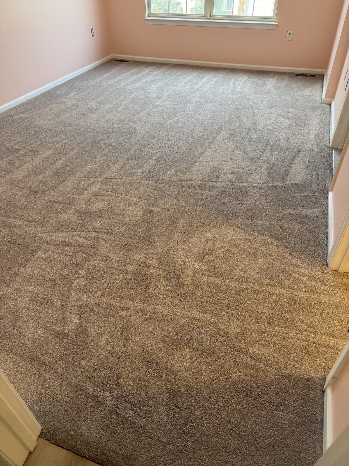 Brand-new bedroom carpet installed wall to wall, beside the same room's worn stained carpet before replacement